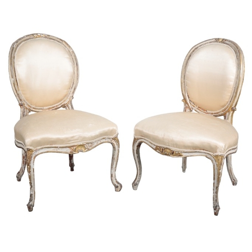 245 - A SUITE OF GEORGE III STYLE WHITE PAINTED AND PARCEL GILT SALON CHAIRS

19th century, comprising two... 