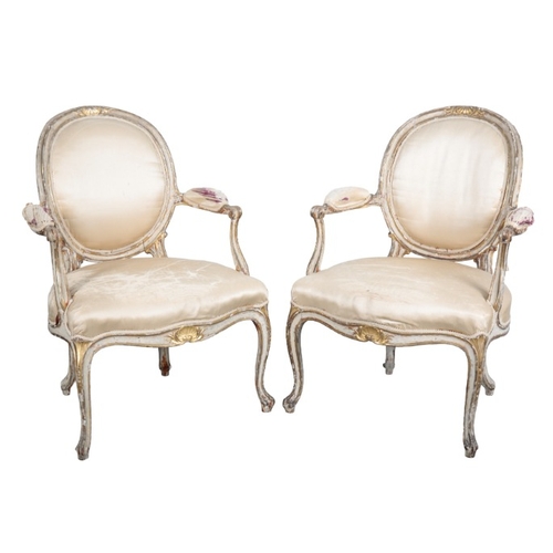 245 - A SUITE OF GEORGE III STYLE WHITE PAINTED AND PARCEL GILT SALON CHAIRS

19th century, comprising two... 