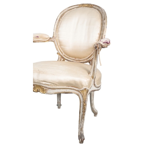 245 - A SUITE OF GEORGE III STYLE WHITE PAINTED AND PARCEL GILT SALON CHAIRS

19th century, comprising two... 