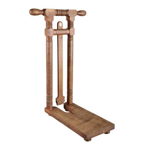 251 - TOM HILL, LONDON: A VICTORIAN COUNTRY HOUSE FREESTANDING OAK BOOT JACK

52cm high x 50cm long