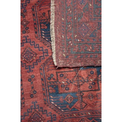 262 - AN ANTIQUE BELUCH BOKHARA CARPET

woven in dark blue and off white with three rows of eight guls, 34... 