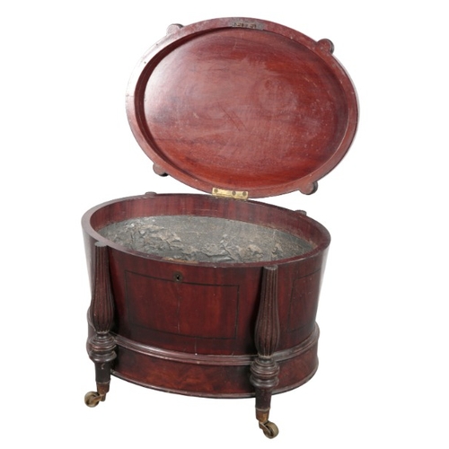 264 - A REGENCY MAHOGANY CELLARETTE IN THE MANNER OF GILLOWS

the fluted hinged lid with a floral finial a... 