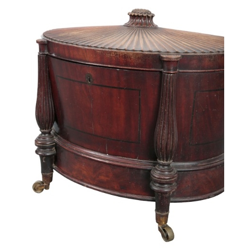 264 - A REGENCY MAHOGANY CELLARETTE IN THE MANNER OF GILLOWS

the fluted hinged lid with a floral finial a... 