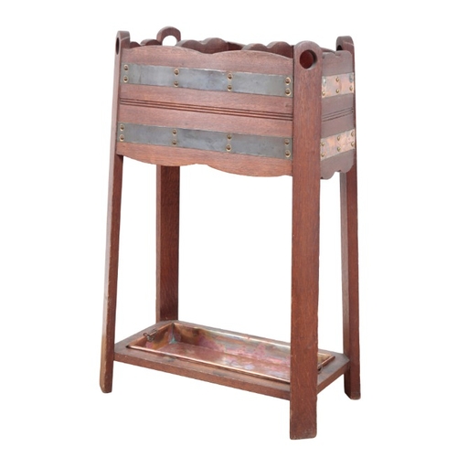 268 - AN ARTS AND CRAFTS OAK AND COPPER-BANDED STICK STAND

with copper drip tray, the copper bands held w... 