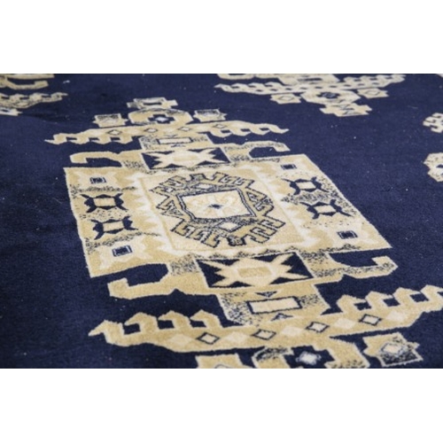 275 - A LARGE PERSIAN CARPET

20th century, the blue ground with eight elephants foot ghuls, 355cm x 252cm