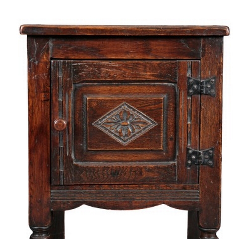 282 - AN ENGLISH OAK CUPBOARD

19th century, the single panelled door carved with a lozenge motif and open... 