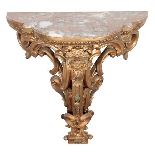 283 - A GILTWOOD AND COMPOSITION WALL BRACKET

the shaped marble top with an egg and dart moulded frieze o... 