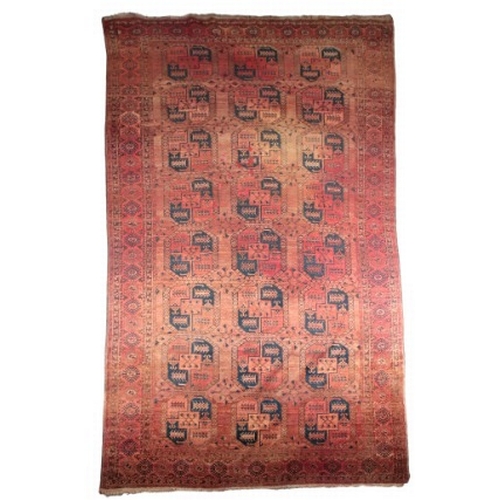 290 - A LARGE ANTIQUE BELUCH CARPET

of Turkoman design, the brick red ground with three rows of elephants... 