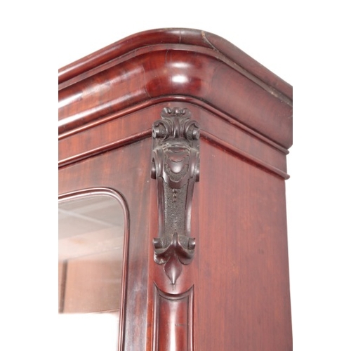 297 - A VICTORIAN MAHOGANY BOOKCASE

the upper section with a moulded cornice over glazed cupboards openin... 