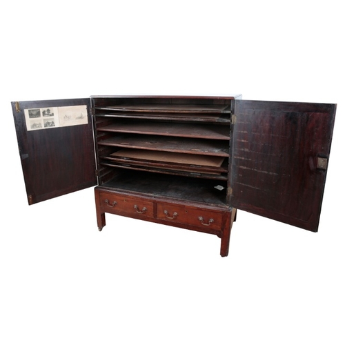 301 - A GEORGE III MAHOGANY LOW PRESS

the upper section with six sliding trays enclosed by hinged cupboar... 