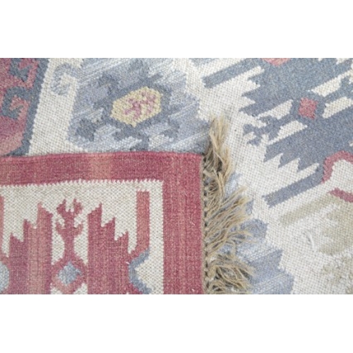 304 - AN ANATOLIAN FLAT WEAVE RUG

20th century, with three central floral medallions within conforming bo... 