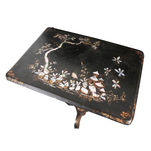 305 - A VICTORIAN PAPIER MACHE TRIPOD TABLE

the rectangular tilt top inlaid with mother of pearl and deco... 