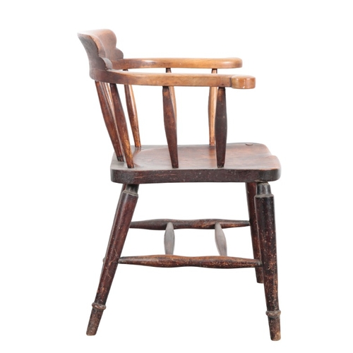 312 - A LATE VICTORIAN SMOKER'S BOW ARMCHAIR

with a shaped elm seat on turned and tapered legs joined by ... 