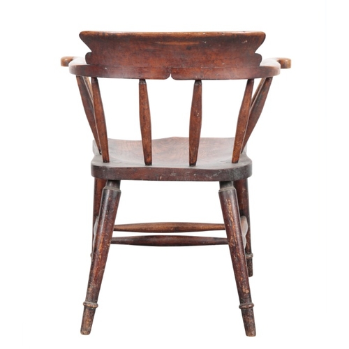 312 - A LATE VICTORIAN SMOKER'S BOW ARMCHAIR

with a shaped elm seat on turned and tapered legs joined by ... 