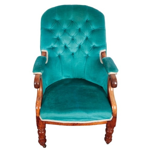 320 - A VICTORIAN WALNUT ARMCHAIR

with button back velvet covers, on turned front legs and outswept rear ... 