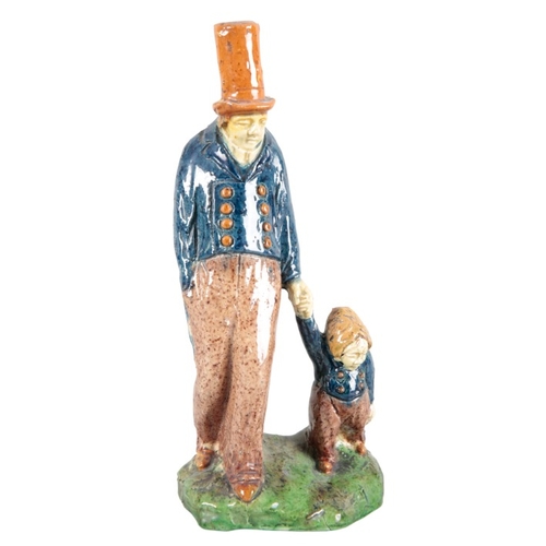 41 - TWO MAJOLICA POTTERY FIGURES

19th century, one modelled as a father wearing a tall hat holding his ... 