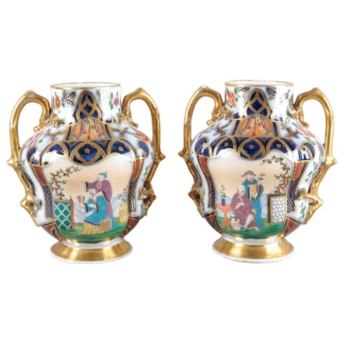 6 - A PAIR OF CONTINENTAL PORCELAIN FACETED VASES

19th century, decorated in the Imari palette with pan... 