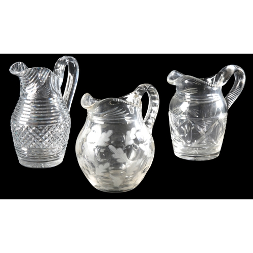 65 - A COLLECTION OF SIX GLASS JUGS

19th and 20th century, including a jug engraved with leaves, 19cm hi... 