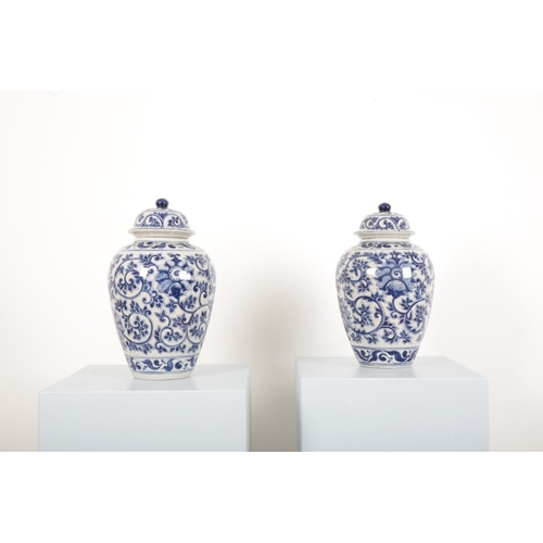 184 - A PAIR OF BLUE AND WHITE PORCELAIN GINGER JARS

the bodies decorated with flowers amongst foliage, e... 