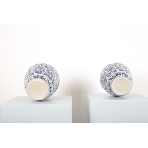 184 - A PAIR OF BLUE AND WHITE PORCELAIN GINGER JARS

the bodies decorated with flowers amongst foliage, e... 