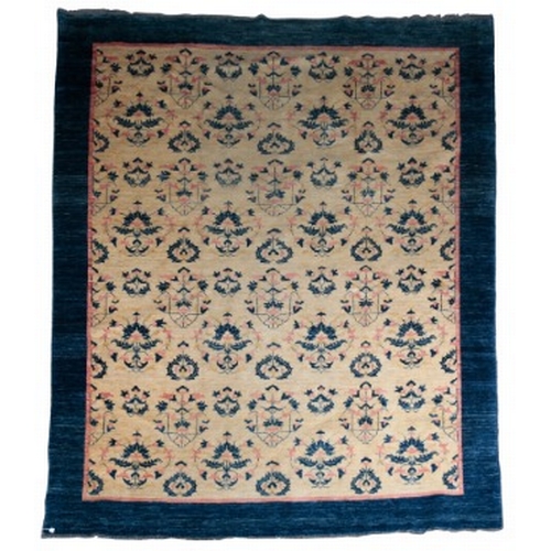 200 - A CONTEMPORARY ARTS AND CRAFTS STYLE CARPET

woven in pink and blue with endless leaf scroll repeat,... 