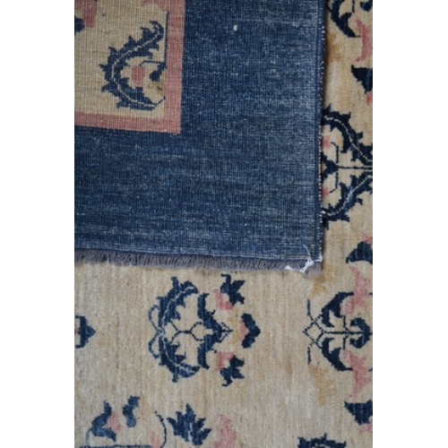 200 - A CONTEMPORARY ARTS AND CRAFTS STYLE CARPET

woven in pink and blue with endless leaf scroll repeat,... 