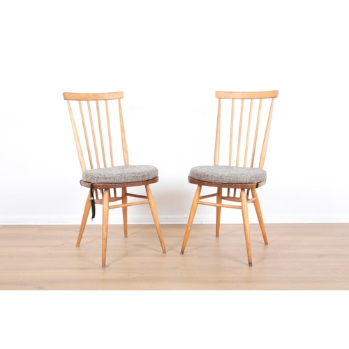 202 - ERCOL, MODEL 365: FOUR BEECH AND ELM 'WINDSOR DINING CHAIRS

mid-century modern; together with anoth... 