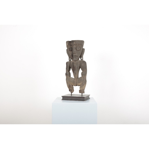 205 - AN AFRICAN CARVED TRIBAL STANDING FIGURE

with pendulous pierced ear lobes, mounted on wooden plinth... 