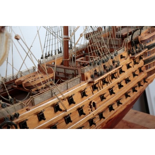 21 - 'HMS VICTORY': A LARGE WOODEN SCALE MODEL OF THE NAVAL WARSHIP

on a wooden stand with plaque, 