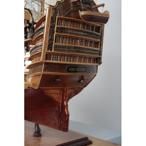 21 - 'HMS VICTORY': A LARGE WOODEN SCALE MODEL OF THE NAVAL WARSHIP

on a wooden stand with plaque, 