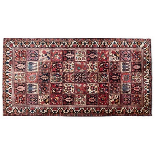 431 - A CENTRAL PERSIAN BAKHTIAR CARPET

a woven 'patchwork' of oblong sections in muted colours containin... 