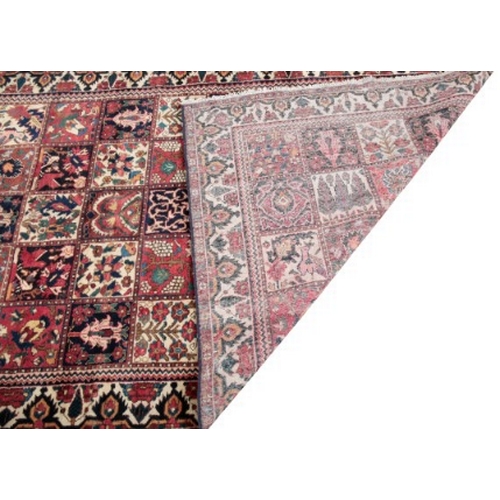 431 - A CENTRAL PERSIAN BAKHTIAR CARPET

a woven 'patchwork' of oblong sections in muted colours containin... 