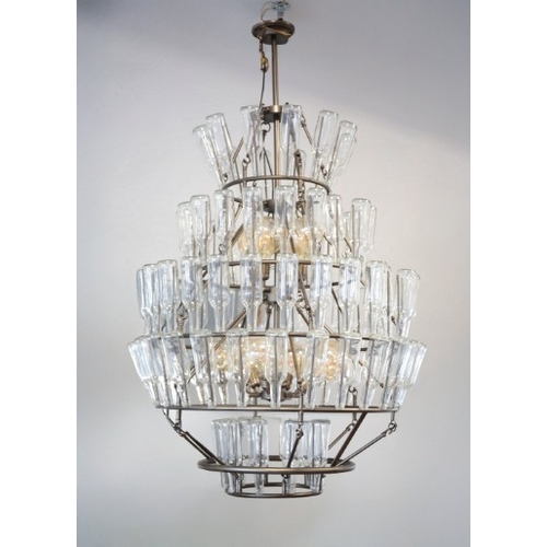 435 - A FIVE TIER GLASS BOTTLE CHANDELIER

a metalwork cage from which glass bottles are suspended, 155cm ... 