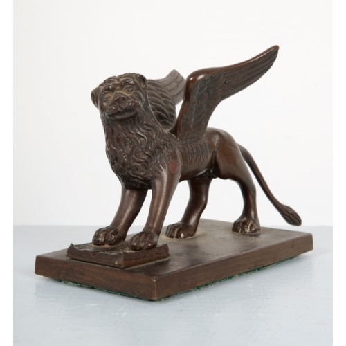 54 - A BRONZE FIGURE OF THE WINGED LION OF VENICE

20th century, standing on a plinth, the front legs res... 