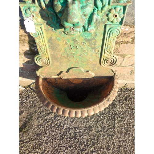 12 - A CAST IRON GARDEN WALL FOUNTAIN

with lion's mask over a semi-circular fluted bowl 76 x 39cm (paint... 