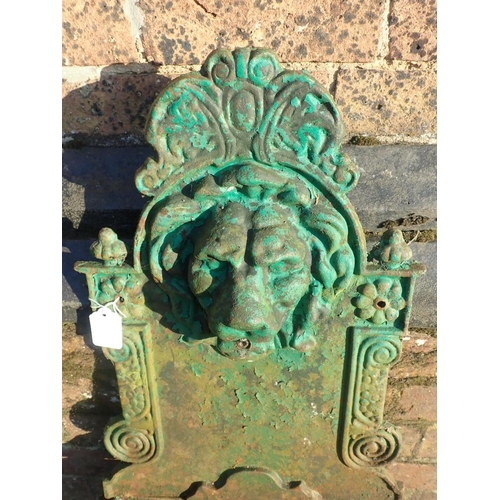 12 - A CAST IRON GARDEN WALL FOUNTAIN

with lion's mask over a semi-circular fluted bowl 76 x 39cm (paint... 