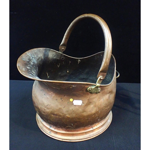 124 - A COPPER COAL SCUTTLE

and set of iron and brass fire tools, on stand