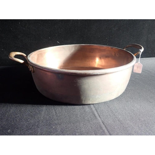 130 - A COPPER TWO HANDLED PRESERVING PAN

43 cms diam.