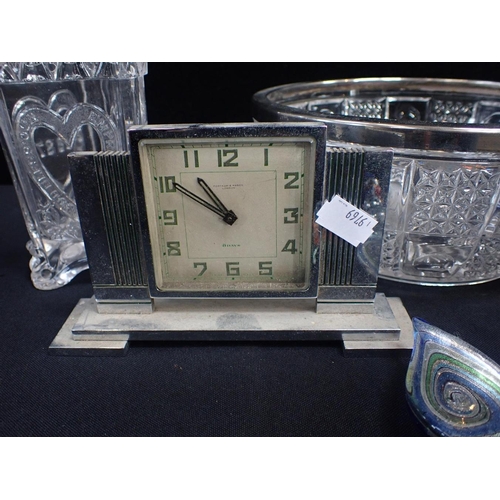 131 - AN ART DECO CHROME CASED CLOCK BY FORTNUM & MASON

a 1960s combined clock and cigarette box, and a  ... 