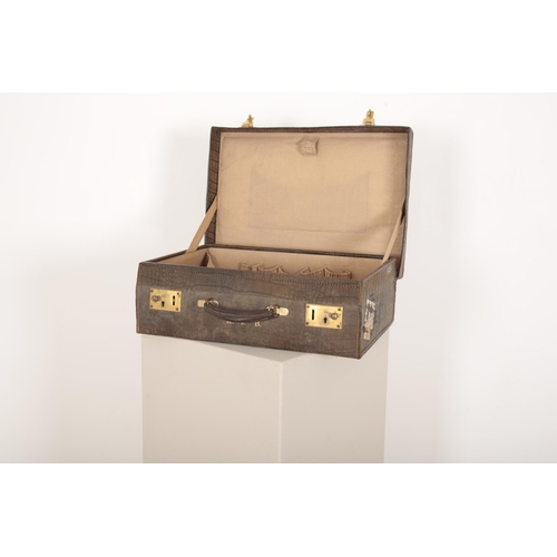 132 - AN EARLY 20th CENTURY GRAINED AND STITCHED LEATHER SMALL SUITCASE

the front with gilt initials K.J.... 