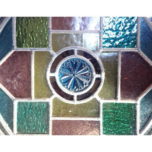 20 - A LEADED GLASS ROUNDEL

with coloured glass and moulded glass details 52cm dia (small damage)