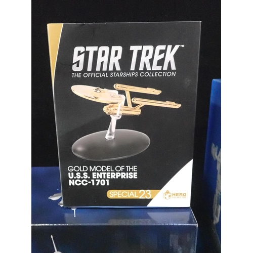 214 - FOUR BOXED EAGLEMOSS HERO COLLECTOR 'STAR TREK' SPACE SHIP MODELS

With a Gold model of the U.S.S. E... 