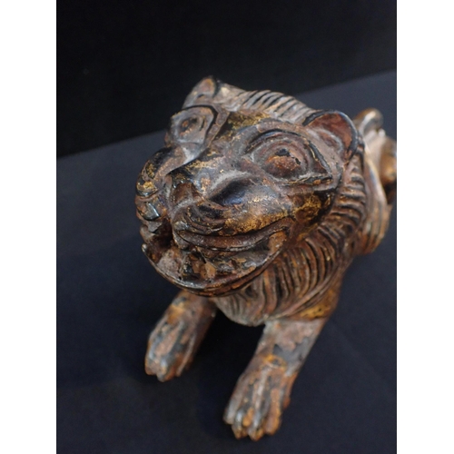 228 - A CARVED AND PAINTED WOOD LION

27cm long