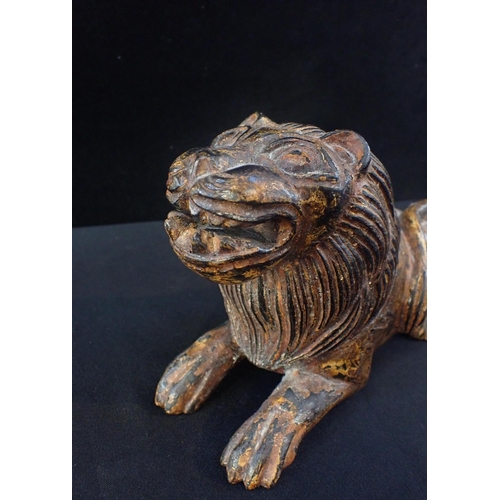 228 - A CARVED AND PAINTED WOOD LION

27cm long