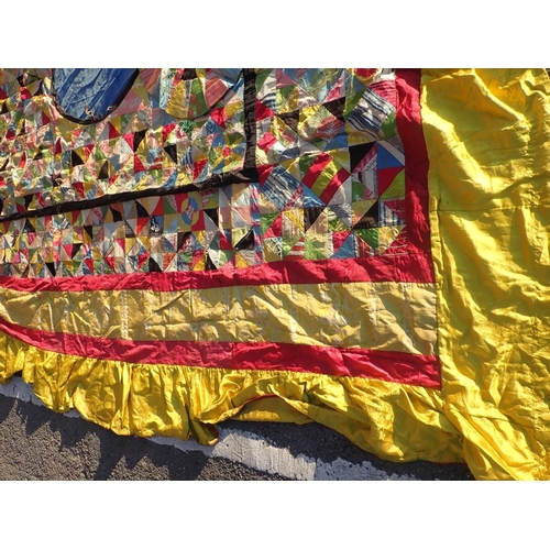 98 - AN ANTIQUE PATCHWORK BED COVER

made with brightly patterned silks and cottons 267 x 245cm (lacking ... 