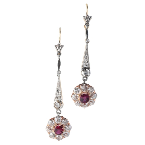 101 - A PAIR OF RUBY AND DIAMOND CLUSTER DROP EARRINGS

in 18ct gold, each comprising a ruby and diamond c... 