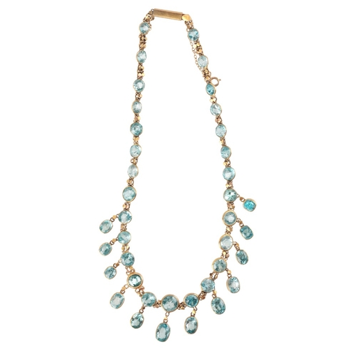 200 - A ZIRCON FRINGE NECKLACE

in 9ct gold, set with round cut and oval cut blue zircons, secured with a ... 