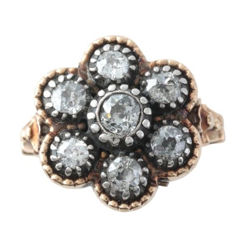 49 - A DIAMOND CLUSTER RING

in silver on gold, set with old cut diamonds totalling c.0.8-1.0 carats, to ... 