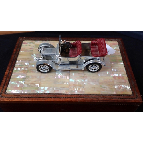 82 - A GROUP OF MODEL CAR MOUNTED DESK ORNAMENTS AND BOXES

wood, ceramic etc, the cars with silvered fin... 