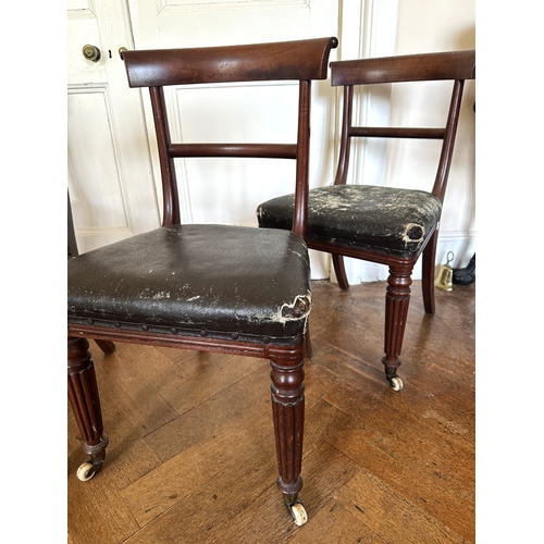 27 - A SET OF FOUR REGENCY MAHOGANY SIDE CHAIRS

the scrolled bar backs over square covered seats, on lob... 